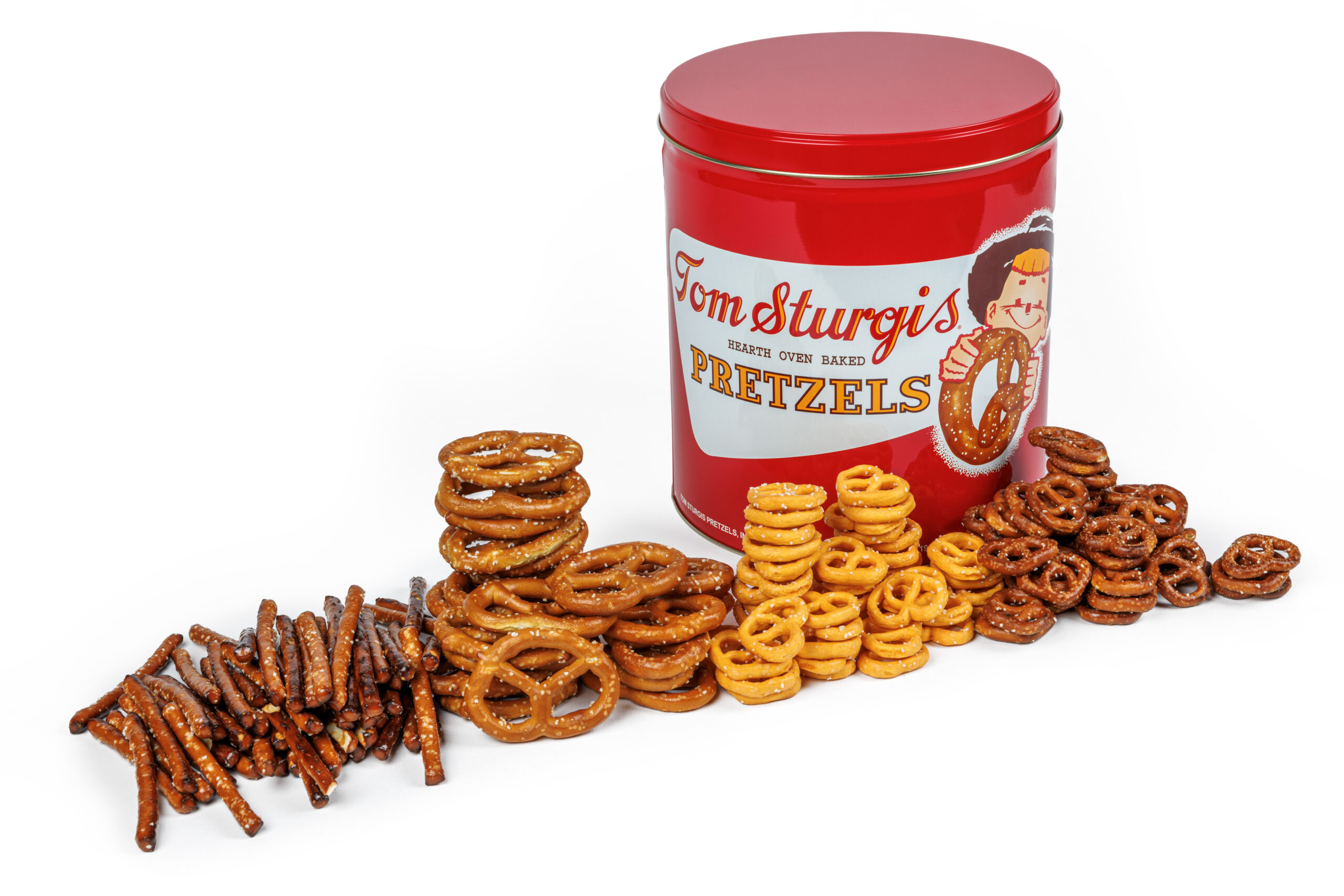 Red tin with pretzels on the table.