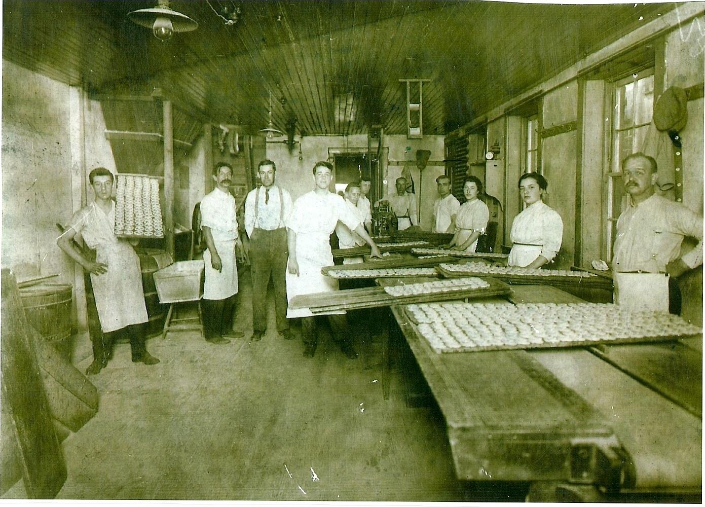 A group of people in a factory at Julius Sturgis Pretzel Bakery, undated.
Description automatically generated
